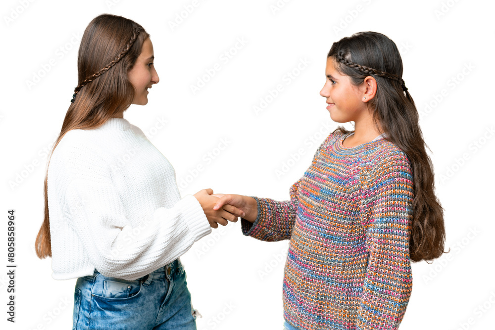 Friends girls over isolated chroma key background handshaking after good deal Friends girls over isolated chroma key background handshaking after good deal