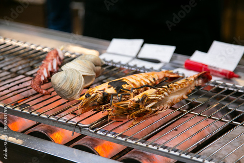 Seafood shell and fish cooked on a grill at the Osaka fish market in Japan.