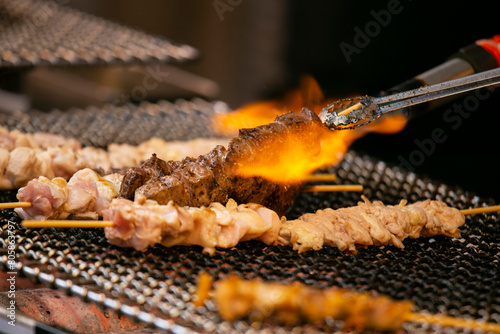 Grilled yakitori chicken skewers at an Izakaya restaurant in Omoide Yokocho street in the Shinjuku district of Tokyo. photo