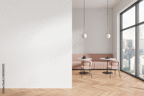 Stylish cafe interior with chairs and eating tables with sofa, window. Mock up wall