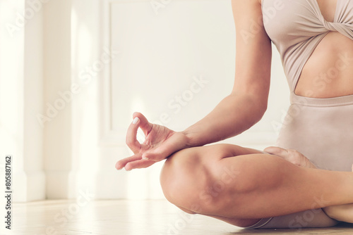 hand lying on the knee and the fingers bent in the zen sign