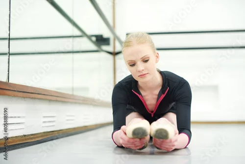 Obraz Woman, ballet and stretching in studio for fitness, exercise and training for dancer for show. Young female ballerina, rehearsal and performance indoor at school of art for creative, artist and barre
