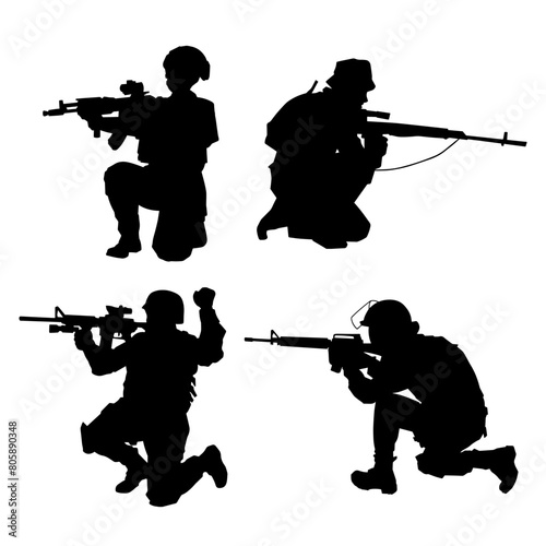 Silhouette of a shooter in squat position. Silhouette of a male soldier in action pose with his machine gun.