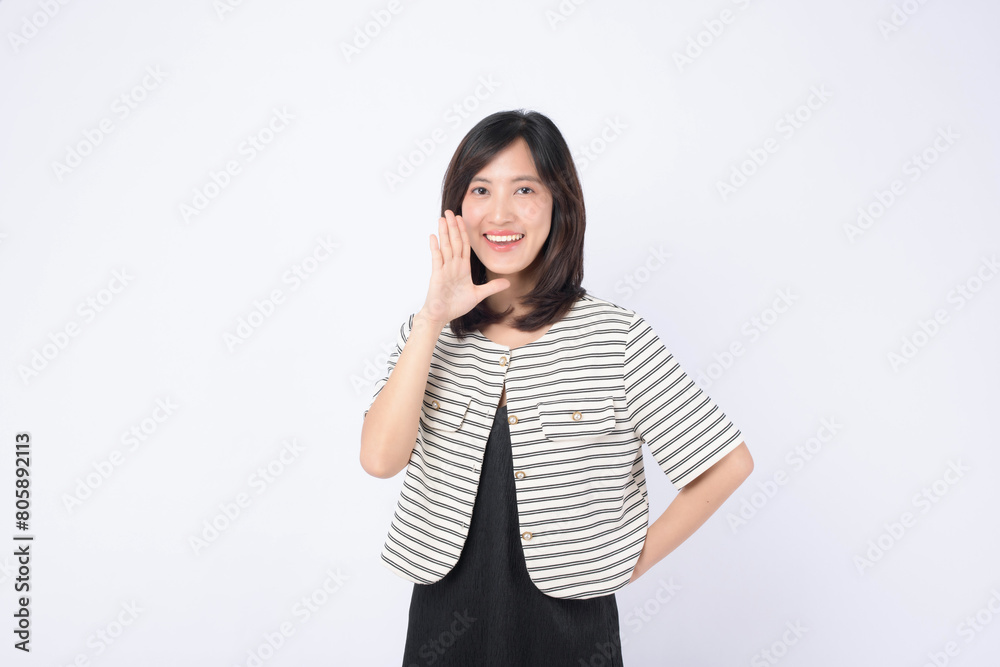 Asian woman is posing with a shouting gesture against a white background. Asian woman is posing with a shouting gesture against a white background.