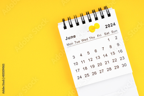 June 2024 Monthly desk calendar for 2024 year with thumbtack on yellow. © gamjai
