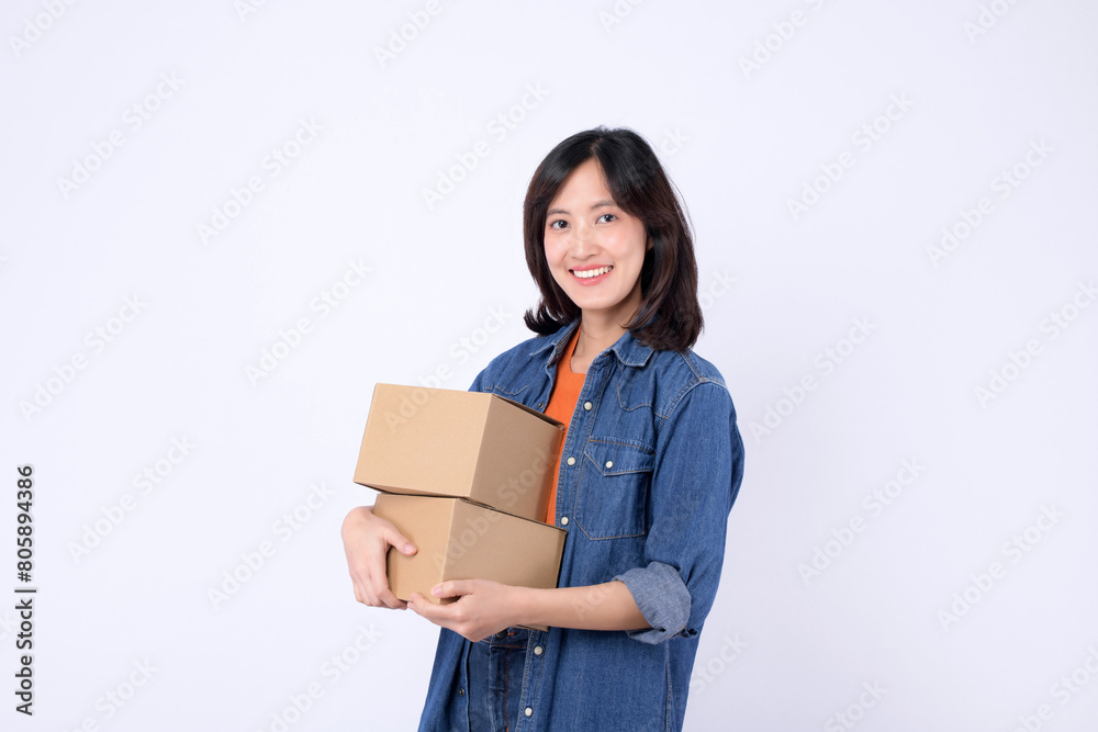 young asian woman wearing orange t-shirt and denim shirt holding parcel box isolated on white studio background, Delivery courier and shipping service concept. young asian woman wearing orange t-shirt and denim shirt holding parcel box isolated on white studio background, Delivery courier and shipping service concept.