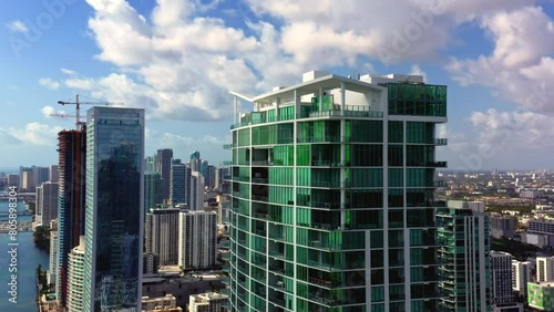 4k Cinematic aerial footage luxury residential ocean view beach front property USA. Real Estate business shot. Design of apartment buildings made of glass and concrete on the bay. Miami, Florida.