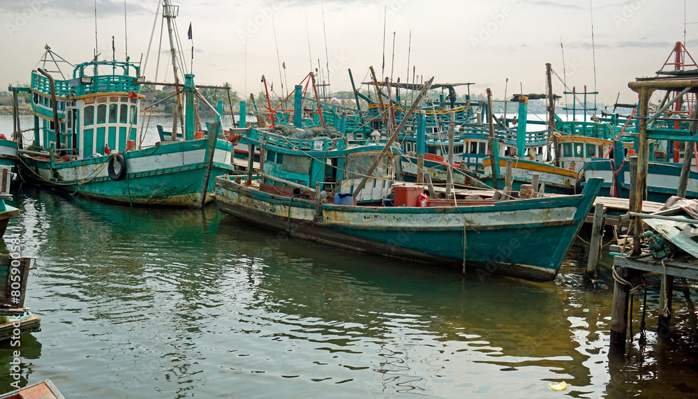 colorful fisher boats in a harbor in kampot