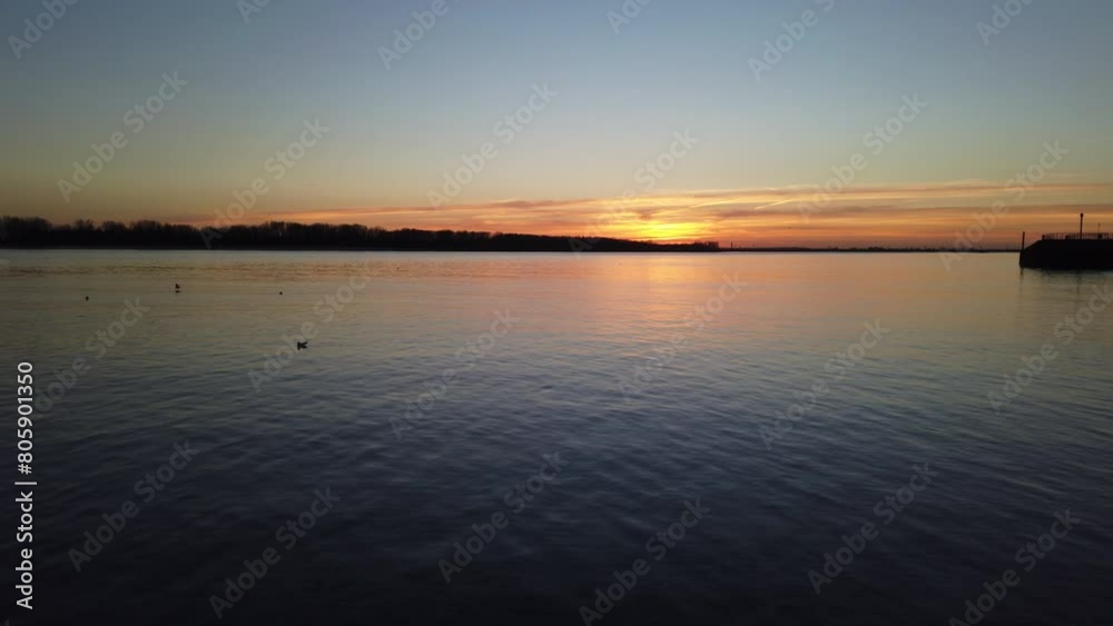 Elbe River at sunset with seagulls in Blankenese, Hamburg Elbe River at sunset with seagulls in Blankenese, Hamburg