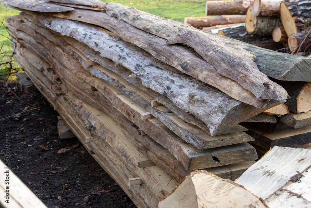 A pile of wooden planks. Stack of cut boards. close-up at a lumber warehouse A pile of wooden planks. Stack of cut boards. close-up at a lumber warehouse