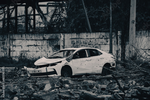 car and destroyed buildings of the workshop of the Azovstal plant in Mariupol