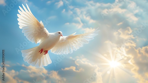 A white dove flaps its wings in the blue sky, with clouds and sunshine behind it. The picture is bright and clean, with a sense of freedom and calmness. White doves symbolize peace and tranquility © horizon