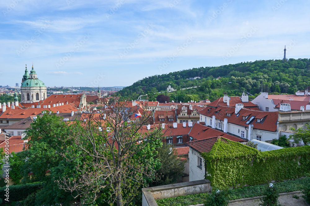 Fototapeta premium Red roof tops of the Lesser town in the Prague, capitol of Czech Republic. Pitoresque part of the big city with old buildings and beautiful historical architecture, popular between tourists from world
