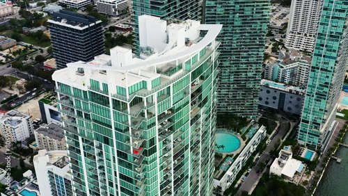 Modern glass and concrete design apartment buildings at the coast Biscayne bay in Miami city. Contemporary urban cityscape view, drone b roll footage 4k. Cinematic aerial footage at cloudy weather. photo