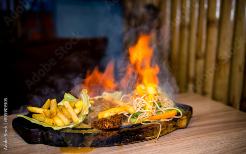 Closeup view of delicious sizzler on table. photo