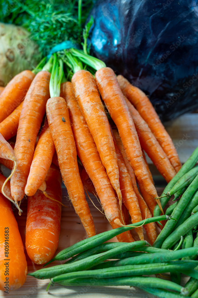 Bunch on fresh orange carrots with green on wooden box Bunch on fresh orange carrots with green on wooden box