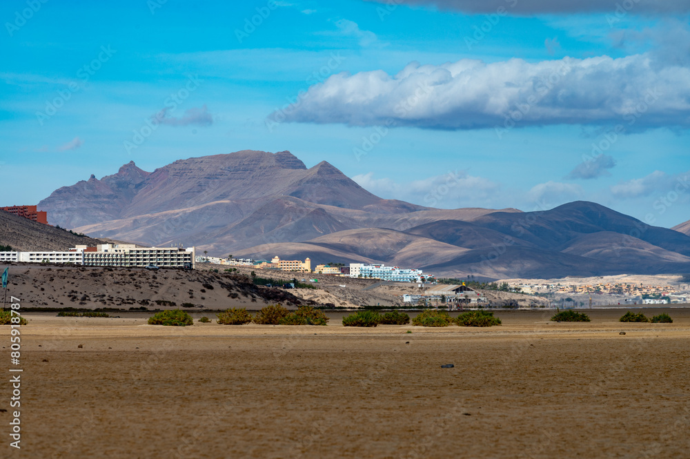 Sandy dunes and hills on Jandia peninsula near Playas de Sotavento en Costa Calma touristic resort, Fuerteventura, Canary islands, Spain