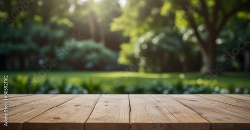 Empty wooden table top with blurred green nature garden background for product placement. Product background