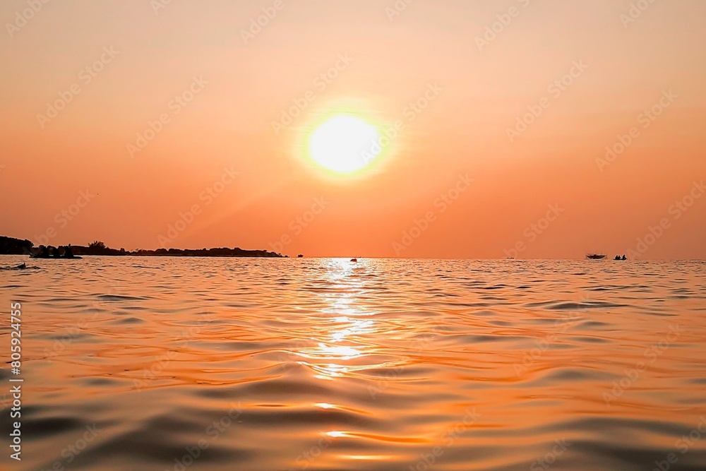 Bright sunset with yellow sun under the sea surface - Summer vacation and nature travel adventure concept. Bright sunset with yellow sun under the sea surface - Summer vacation and nature travel adventure concept.