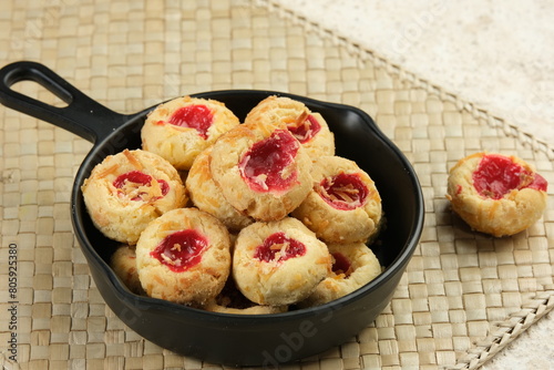 Homemade thumb print cookies or Hallongrottor or Swedish rapsberry caves jam cookies,filled with strawberry jam and grated cheese photo