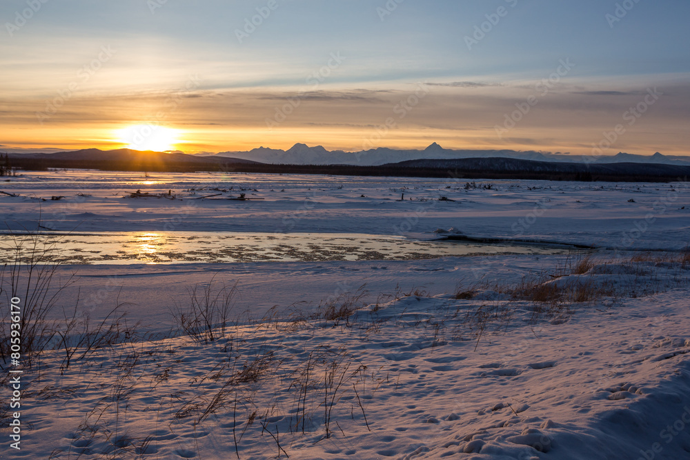 Beautiful view of Tanana River landscape in frozen weather in Alaskan winter in sunset