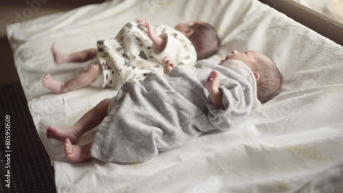 Twin male and female babe crying while moving their arms and legs (2)