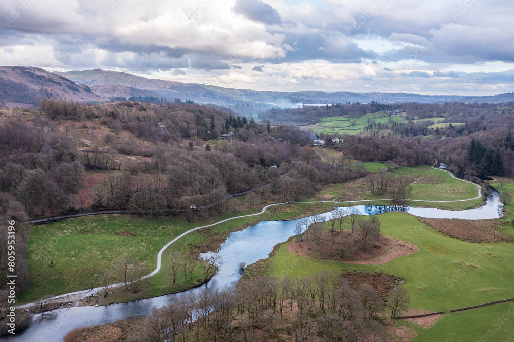 Fototapeta premium Stunning aerial drone landscape image over River Brathay near Elterwater in Lake District with Langdale Pikes in distance