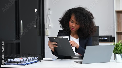 Businesswoman Analyzing Finance on Tablet and Laptop at modern Office Desk tax