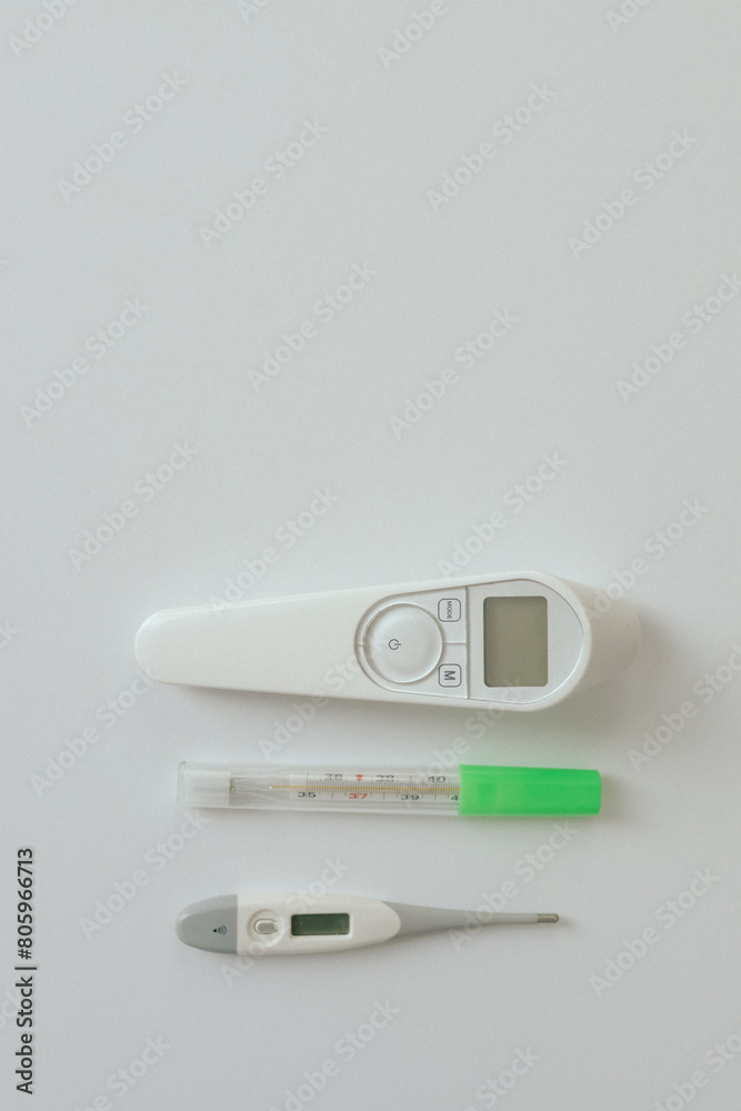 Comparison of mercury thermometer, infrared and electronic thermometer baby thermometer for measuring human body temperature on light background. Types of thermometers. Copy space Comparison of mercury thermometer, infrared and electronic thermometer baby thermometer for measuring human body temperature on light background. Types of thermometers. Copy space