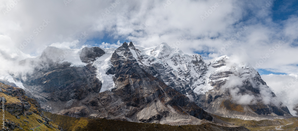 77MP Panoramic photo Mera peak 6476m with glacier lakes and snowy summits covered in white clouds. Himalayas climbing route near the Khare settlement, Makalu Barun National Park trek in Nepal.