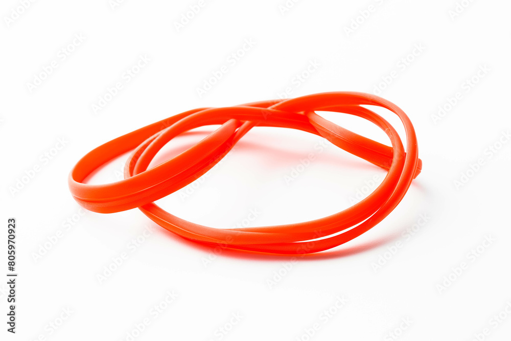 A bright red rubber band, stretched and twisted into an interesting shape, resting on a stark white background. A bright red rubber band, stretched and twisted into an interesting shape, resting on a stark white background.
