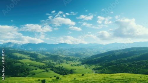 Panoramic view of green hills with clouds and blue sky seen from the plateau. Summer background.