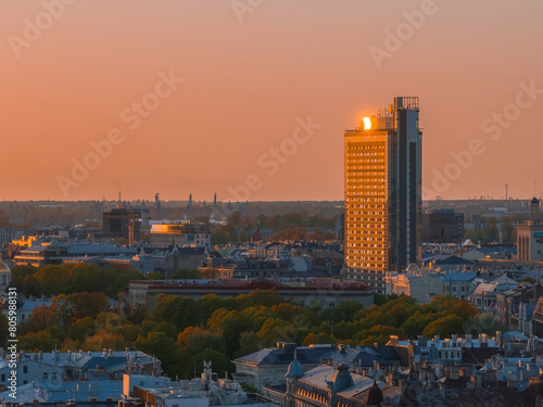 Aerial panoramic sunset over Riga old town in Latvia. Beautiful spring sunset over Riga. Golden hour fire sunset.