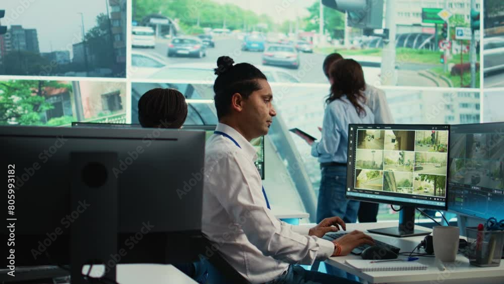 Indian worker operating on license plate registration via CCTV radar footage, working with video surveillance system in real time. Government employee monitoring traffic. Camera B.