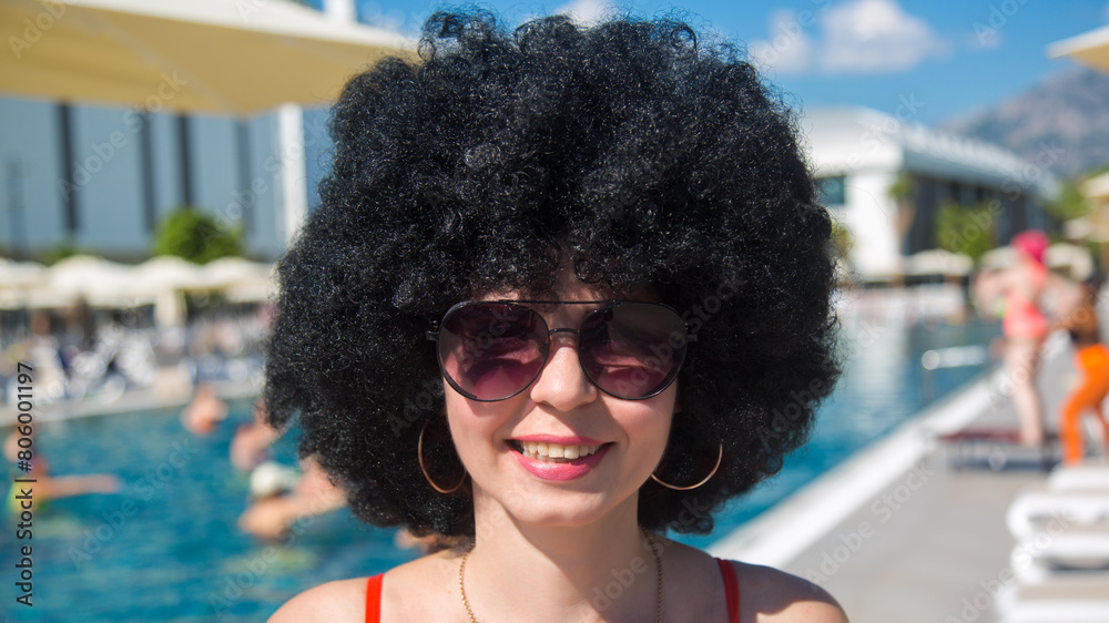 Summer day by the pool smiling woman with black curly hair., Summer day by the pool smiling woman with black curly hair.,
