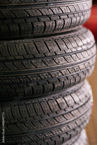 Tyres, pile and wheel in garage for repairs, rubber and fixing or replace fitting on car at shop. Closeup, store and service or safety check or inspection, motor and alignment of vehicle to change © peopleimages.com