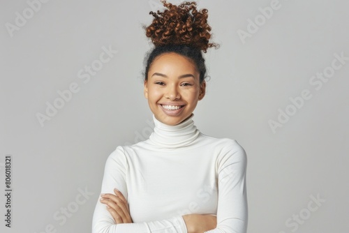 Portrait of attractive cheerful smiling woman in white turtleneck sweater standing with arms crossed looking at camera over isolated background, copy space for text banner design. 