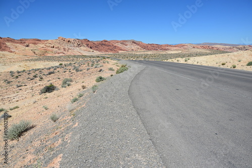 Road running through The Valley of Fire state park on a scorching April day in 2024.