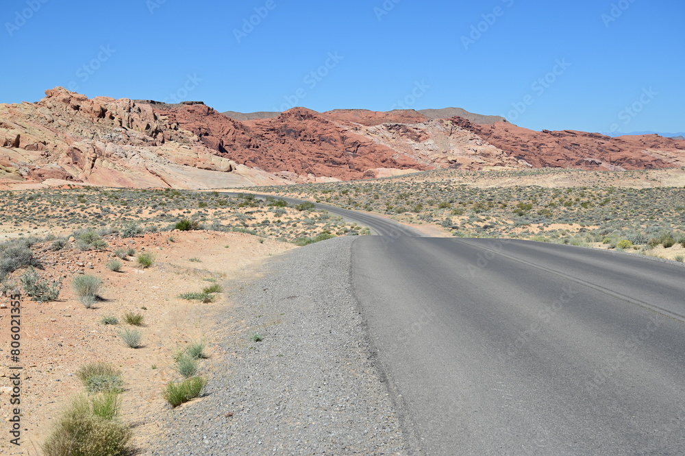 Road running through The Valley of Fire state park on a scorching April day in 2024.
