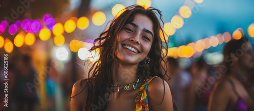 A woman with long hair is smiling and wearing a necklace photo