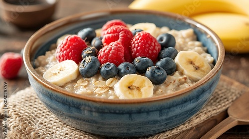 Healthy Bowl of Oatmeal with Fresh Raspberries, Blueberries, and Banana Slices, Highlighting a Delicious and Nutritious Breakfast Option.
