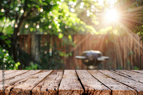 BBQ grill in the yard background with empty wooden table