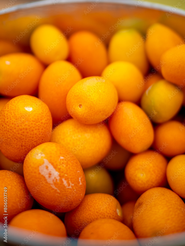A bowl brimming with freshly harvested little Kumquat organic citrus fruits, offering a vital nutritious choice ready to enjoy and embodying the essence of wholesome refreshment and natural goodness. A bowl brimming with freshly harvested little Kumquat organic citrus fruits, offering a vital nutritious choice ready to enjoy and embodying the essence of wholesome refreshment and natural goodness.