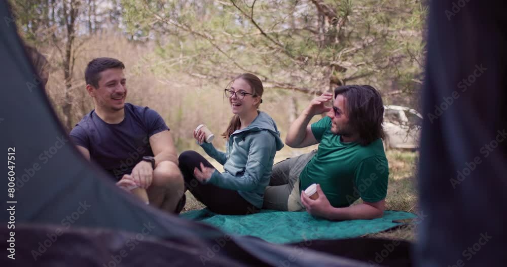 A group of friends enjoying a relaxing moment while sharing coffee in a scenic natural setting during their camping trip. Capturing laughter and togetherness. A group of friends enjoying a relaxing moment while sharing coffee in a scenic natural setting during their camping trip. Capturing laughter and togetherness.