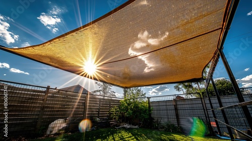 A reflective sun shade over a cat enclosure  allowing safe outdoor time without the risk of overheating.