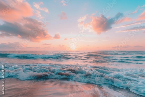 Pastel sunset reflecting on gentle waves at serene beach