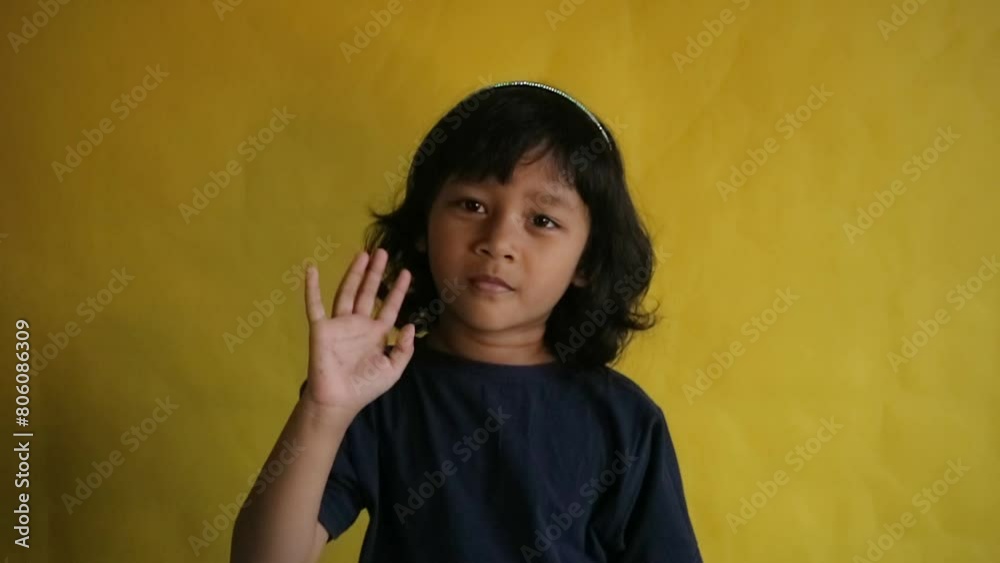a little girl waving her hand a little girl waving her hand