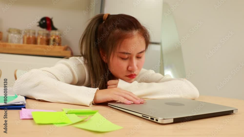 Tired exhausted, fatigue and fell asleep. Yaoung asian thai female working on laptop in kitchen room at home. Overwork. Exhausted woman sleeply eye at workplace Tired exhausted, fatigue and fell asleep. Yaoung asian thai female working on laptop in kitchen room at home. Overwork. Exhausted woman sleeply eye at workplace