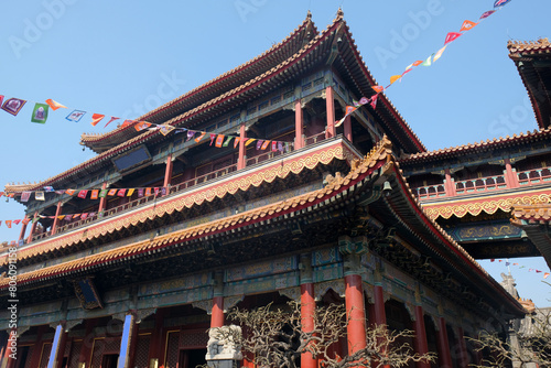 Chinese temple and flags against blue sky