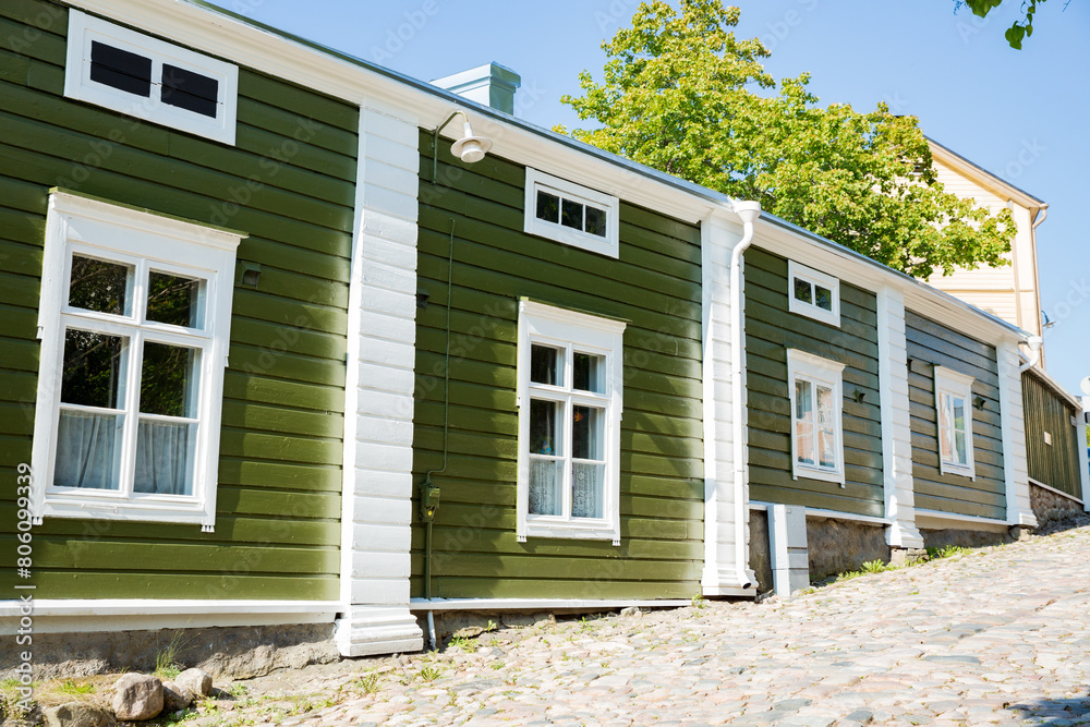 Porvoo, Finland. Narrow streets of Old town of Porvoo. Picturesque colorful wooden houses. Historic center, touristic place, landmark of Finland. Warm sunny summer day in nordic country. Porvoo, Finland. Narrow streets of Old town of Porvoo. Picturesque colorful wooden houses. Historic center, touristic place, landmark of Finland. Warm sunny summer day in nordic country.